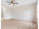 Unfurnished bedroom with hardwood-style flooring, light colored walls, and an ensuite bathroom at 4065 Lost Creek Ct, Hickory, NC 28602