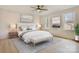 Staged bedroom featuring a bed, neutral decor, windows, and hardwood-style flooring at 4065 Lost Creek Ct, Hickory, NC 28602