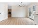 Dining area with access to a deck, showcasing light-colored flooring, and a distant fireplace at 4065 Lost Creek Ct, Hickory, NC 28602