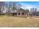 Charming brick home with a covered carport and inviting front porch, set on a spacious lawn at 4065 Lost Creek Ct, Hickory, NC 28602