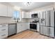Modern kitchen featuring stainless steel appliances, white cabinetry, and light countertops at 4065 Lost Creek Ct, Hickory, NC 28602