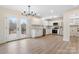 Modern white kitchen featuring stainless steel appliances, a stylish chandelier, and French doors at 4065 Lost Creek Ct, Hickory, NC 28602