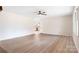 Open living room with wood-look floors, neutral walls, and a glimpse into the modern kitchen at 4065 Lost Creek Ct, Hickory, NC 28602