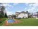 A spacious backyard with a pool, seating areas, and a well-maintained lawn, perfect for outdoor enjoyment at 4131 Nottaway Place Dr, Matthews, NC 28105