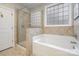 Modern bathroom with a glass-enclosed shower and a separate soaking tub at 4131 Nottaway Place Dr, Matthews, NC 28105