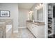 Bright bathroom with double vanity, granite countertops, and a walk-in closet at 4131 Nottaway Place Dr, Matthews, NC 28105