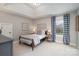 Comfortable bedroom with large window, stylish decor, and plenty of natural light at 4131 Nottaway Place Dr, Matthews, NC 28105