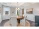 Bright dining room with elegant chandelier, wainscoting, and a view of the backyard, perfect for Gathering dinners at 4131 Nottaway Place Dr, Matthews, NC 28105