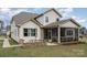 Rear exterior of home with a screened in porch, outdoor seating, and brick patio features at 4131 Nottaway Place Dr, Matthews, NC 28105