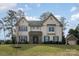 Beautiful two-story home with stone accents, manicured lawn, and a separate garage; perfect for a Gathering at 4131 Nottaway Place Dr, Matthews, NC 28105