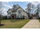 Charming two-story home with a stone-accented entrance, a long driveway, and a detached garage at 4131 Nottaway Place Dr, Matthews, NC 28105