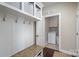 Functional mudroom with storage, hooks, and a bench, leading to the laundry room with a washer and dryer at 4131 Nottaway Place Dr, Matthews, NC 28105