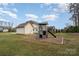 Backyard playground, featuring a slide, climbing areas, and a wood-chip ground cover for safe play at 4131 Nottaway Place Dr, Matthews, NC 28105