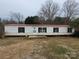 Modest single-story home with a red roof and horizontal white siding on an overcast day at 4161 Slanting Bridge Rd, Sherrills Ford, NC 28673
