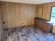 Cozy room with wood-paneled walls, base cabinets, and durable flooring at 4161 Slanting Bridge Rd, Sherrills Ford, NC 28673