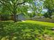 Expansive backyard with a storage shed and mature trees, perfect for outdoor activities at 4930 Crestmont Dr, Charlotte, NC 28205