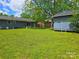 Spacious backyard view featuring a shed, tree, and neutral exterior paint at 4930 Crestmont Dr, Charlotte, NC 28205
