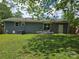 Private backyard with a small patio, grassy area, and neutral exterior paint at 4930 Crestmont Dr, Charlotte, NC 28205