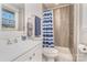 Bright bathroom with a white vanity, toilet, and shower/tub combination featuring stylish tile work and a curtain at 4930 Crestmont Dr, Charlotte, NC 28205