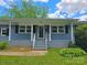 Close-up of home's entrance, highlighting the covered porch and inviting curb appeal at 4930 Crestmont Dr, Charlotte, NC 28205