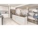 Open kitchen featuring an island, modern stainless-steel appliances, and white cabinetry at 4930 Crestmont Dr, Charlotte, NC 28205
