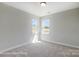 Bright and airy bedroom featuring neutral carpet and natural light from two bright windows at 5104 Heathland Dr # 73, Charlotte, NC 28215