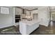 Modern kitchen features white cabinetry, a center island with counter seating, and stainless steel appliances at 5104 Heathland Dr # 73, Charlotte, NC 28215