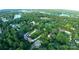Aerial view of a neighborhood by the lake, with lush green trees and beautiful homes at 6108 Gold Creek Estate Dr, Hickory, NC 28601