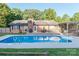 Backyard swimming pool with a wooden deck and outdoor seating area at 6108 Gold Creek Estate Dr, Hickory, NC 28601