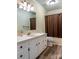 Well-lit bathroom featuring a white vanity and shower at 6108 Gold Creek Estate Dr, Hickory, NC 28601