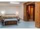 Bedroom featuring neutral colors, a bed, and wood-paneled doorway to the bathroom at 6108 Gold Creek Estate Dr, Hickory, NC 28601
