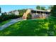 Attractive front elevation featuring a welcoming porch and lush landscaping at 6108 Gold Creek Estate Dr, Hickory, NC 28601