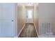 Neutral hallway with new floors and white door, offering ample storage at 6108 Gold Creek Estate Dr, Hickory, NC 28601