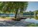 Picturesque lake scene with dock, picnic table, and mature tree at 6108 Gold Creek Estate Dr, Hickory, NC 28601