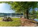 Scenic lakeside view with a picnic table, dock, and lush green surroundings at 6108 Gold Creek Estate Dr, Hickory, NC 28601