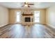 Bright living room with brick fireplace and light-filled windows at 6108 Gold Creek Estate Dr, Hickory, NC 28601