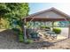 Covered outdoor seating area with tables, chairs, and scenic lake views offers a relaxing community gathering space at 6108 Gold Creek Estate Dr, Hickory, NC 28601