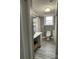 Bathroom featuring a toilet, sink with white cabinet, and window at 818 W 6Th St, Newton, NC 28658