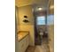 Bathroom featuring a toilet, sink with white cabinet, and window at 818 W 6Th St, Newton, NC 28658