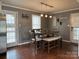 Bright dining area features a farmhouse table, bench, and a pendant light fixture at 818 W 6Th St, Newton, NC 28658