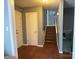 Foyer with hardwood floors, staircase, and access to the front door at 818 W 6Th St, Newton, NC 28658