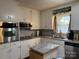 Updated kitchen with granite countertops, stainless steel appliances, and white cabinets at 818 W 6Th St, Newton, NC 28658