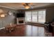 Cozy living room features a ceiling fan, fireplace, and a large window offering natural light at 818 W 6Th St, Newton, NC 28658