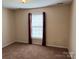 Neutral bedroom with window and decorative dark red curtains at 823 Prestwick Dr, Rock Hill, SC 29730