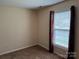 Neutral bedroom with window and decorative dark red curtains at 823 Prestwick Dr, Rock Hill, SC 29730