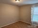 Cozy bedroom with neutral walls, carpet floors, window with curtain, and plenty of natural light at 823 Prestwick Dr, Rock Hill, SC 29730