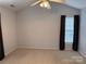 Neutral bedroom with ceiling fan and window with dark curtains at 823 Prestwick Dr, Rock Hill, SC 29730