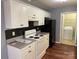 Open kitchen featuring stainless steel appliances, white cabinets, and a view to the laundry room at 823 Prestwick Dr, Rock Hill, SC 29730
