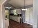 The kitchen features white cabinetry, stainless appliances, hardwood flooring and a dining area at 823 Prestwick Dr, Rock Hill, SC 29730