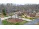 Overhead view of brick home with a long driveway nestled amongst the trees at 920 Hunting Ave, Lincolnton, NC 28092